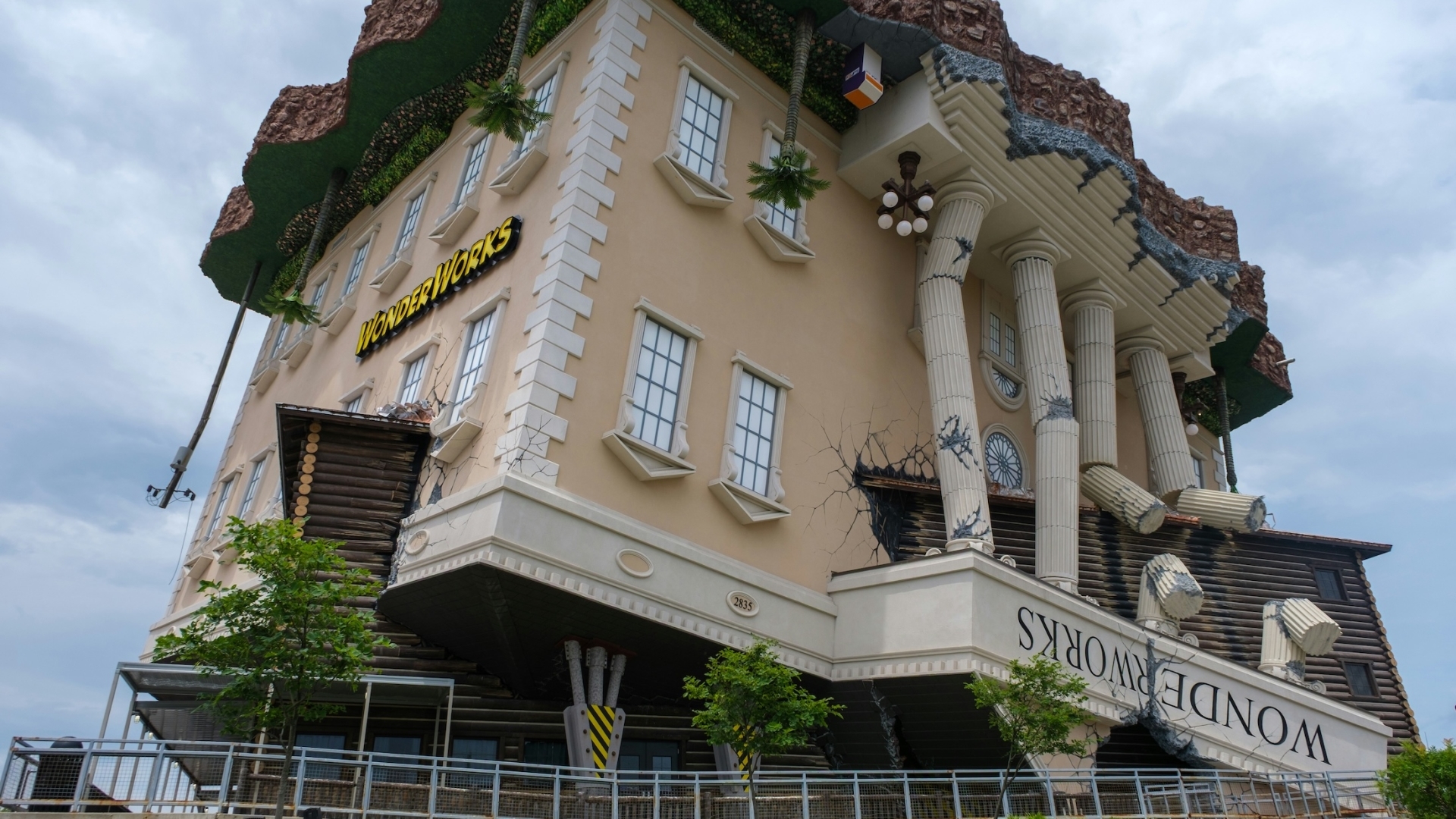 The famous upside-down building facade of the WonderWorks attraction in Orlando, designed to look like a classic brick building ripped from its foundation.
